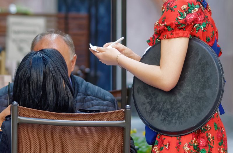 A waitress taking an order at a table. Image courtesy Pixabay.